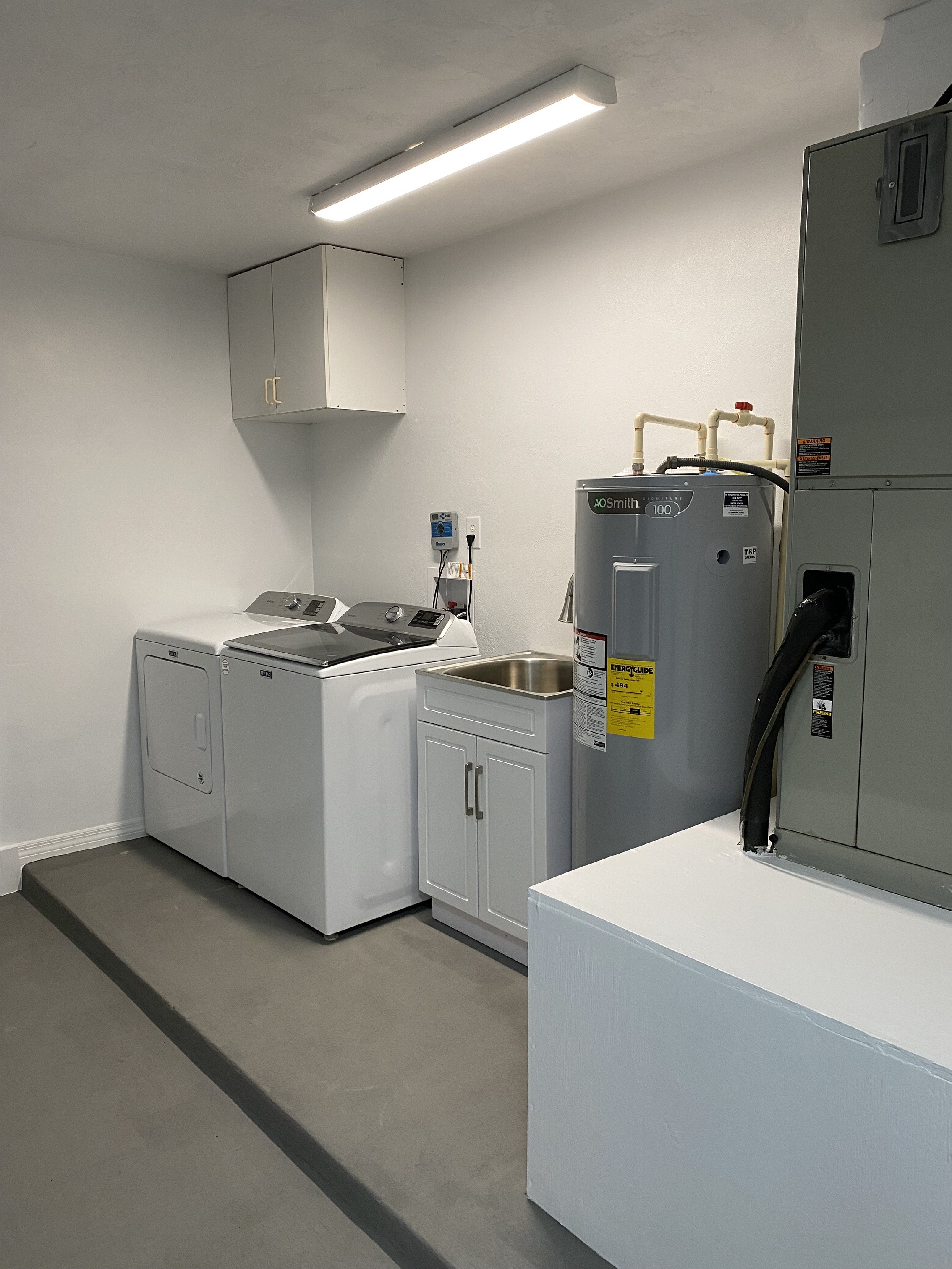 Indoor Utility room with built in shelves and cabinets